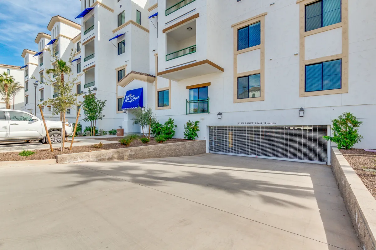 This image showcases The Cays' modern architectural design, featuring green balconies and well-manicured landscaping. The communal outdoor areas invite residents to socialize and experience a warm, welcoming environment.